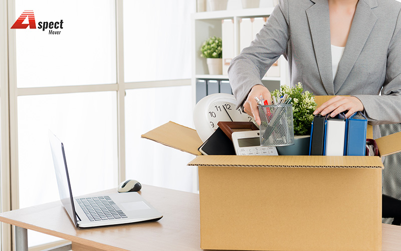 woman packing her things for office moving